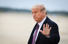 An  October 1, 2020 photo shows US President Donald Trump upon arrival at Andrews Air Force Base in Maryland on October 1, 2020 after he returned to Washington, DC following a  fundraiser in Bedminster, New Jersey. (Photo by MANDEL NGAN / AFP)