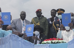 Chairman of Sudan's Sovereign Council Abdel Fattah al-Burhan (L), South Sudan's President Salva Kiir (C) and Chadian President Idriss Deby (R) hold a copy of the South Sudan peace deal, signed in Juba on October 3, 2020. - Sudan's government and rebel groups on Saturday signed a landmark peace deal aimed at ending decades of war in which hundreds of thousands have died. (Photo by Majak Kuany / AFP)