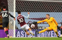 Aston Villa's English midfielder Jack Grealish (C) scores their seventh goal past Liverpool's Spanish goalkeeper Adrian during the English Premier League football match between Aston Villa and Liverpool at Villa Park in Birmingham, central England on October 4, 2020. (Photo by Catherine Ivill / POOL / AFP)