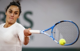 Italy's Martina Trevisan returns the ball to Poland's Iga Swiatek during their women's singles quarter-final tennis match on Day 10 of The Roland Garros 2020 French Open tennis tournament in Paris on October 6, 2020. (Photo by Thomas SAMSON / AFP)