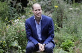 (FILES) In this file photo taken on July 16, 2020, Britain's Prince William, Duke of Cambridge socially distances as he speaks with service users during a visit to the Garden House of the Light Project in Peterborough. - Britain's Prince William on Thursday launched the "most prestigious" environmental prize of all time, aimed at turning "pessimism into optimism" by rewarding innovative solutions to the planet's biggest problems. (Photo by Kirsty Wigglesworth / POOL / AFP)