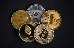 (FILES) In this file photo taken on January 26, 2020 a photo shows physical imitations of cryptocurrency. Finance ministers from the G7 industrialized countries expressed "concern" on October 13, over the rise in "malicious cyber-attacks", with some involving digital currencies. PHOTO: INA FASSBENDER / AFP
