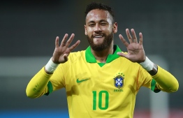 Brazil's Neymar celebrates after scoring a penalty against Peru during their 2022 FIFA World Cup South American qualifier football match at the National Stadium in Lima, on October 13, 2020, amid the COVID-19 novel coronavirus pandemic. (Photo by Daniel APUY / various sources / AFP)