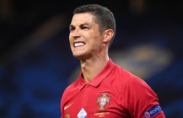 (FILES) In this file photo taken on September 08, 2020 Portugal's forward Cristiano Ronaldo reacts after scoring his second goal during the UEFA Nations League football match between Sweden and Portugal on September 8, 2020 in Solna, Sweden. - Cristiano Ronaldo has tested positive for Covid-19, the Portuguese Football Federation announced on October 13, 2020. (Photo by Jonathan NACKSTRAND / AFP)
