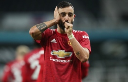 Manchester United's Portuguese midfielder Bruno Fernandes celebrates scoring during the English Premier League football match between Newcastle United and Manchester United at St James' Park in Newcastle-upon-Tyne, north east England on October 17, 2020. (Photo by Alex Pantling / POOL / AFP)