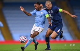 Manchester City's English midfielder Raheem Sterling (L) vies with Porto's Portuguese defender Pepe (R) during the UEFA Champions League football Group C match between Manchester City and Porto at the Etihad Stadium in Manchester, north west England on October 21, 2020. (Photo by Laurence Griffiths / POOL / AFP)