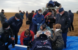 Russian cosmonaut Anatoly Ivanishin gets medical check shortly after landing in a remote area outside the town of Dzhezkazgan (Zhezkazgan), Kazakhstan, on October 22, 2020. - An American astronaut and two Russian cosmonauts touched down safely on the Kazakhstan steppe on October 22, completing a 196-day mission that began with the first launch under lockdown conditions. (Photo by Handout / Rosaviatsiya / AFP) / 