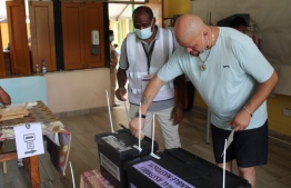 A voter casts his ballot at the English River polling station during the early voting for the presidential and legislative elections, in Victoria on October 22, 2020. - The Seychelles on October 22, 2020, kicked off three days of voting for the president and lawmakers, with polling to be spread out across the 115 scattered islands making up the idyllic archipelago. (Photo by Rassin VANNIER / AFP)