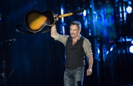 (FILES) In this file photo taken on November 11, 2014 Bruce Springsteen performs during "The Concert for Valor" on the National Mall in Washington, DC. - The Boss got the band back together for his 20th studio album out October 23, 2020, a work that sees the ever-reflective Bruce Springsteen converse with his past selves while meditating on his own mortality. Springsteen's album "Letter to You" fits neatly into his canon, a return to the layered guitars, dramatic percussion and glockenspiel that swelled into the signature sound he coined with his E Street Band, the group he's performed with since 1972. (Photo by BRENDAN SMIALOWSKI / AFP)