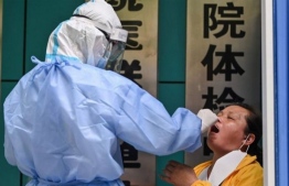 Following is a brief timeline of COVID19 in the year 2020 and the undeniable change sparked by the unprecedented circumstances that followed. Pictured above is a health professional procuring a sample from a Chinese national in China mainland, to be tested for the novel coronavirus earlier this year. PHOTO: AFP