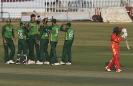 Pakistan's Shaheen Afridi (3L) celebrates with teammates after the dismissal of Zimbabwe's Brian Chari (R) during the first one-day international (ODI) cricket match between Pakistan and Zimbabwe at the Rawalpindi Cricket Stadium in Rawalpindi on October 30, 2020. (Photo by Aamir QURESHI / AFP)