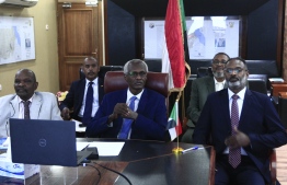 Sudan's Minister of Irrigation and Water Resources Yasser Abbas (C) participates in a videoconference with his Egyptian and Ethiopian counterparts (unseen) in the Sudanese capital Khartoum on November 1, 2020. - Khartoum said it is to organise a week of negotiations on Ethiopia's controversial dam on the Nile that has riled downstream neighbours Egypt and Sudan, following a three-way videoconference. (Photo by Ebrahim HAMID / AFP)