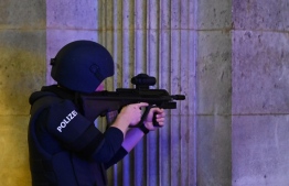 An armed policeman guards the passage of the state opera in central Vienna on November 2, 2020, following a shooting near a synagogue. - Multiple gunshots were fired in central Vienna on Monday evening, according to police, with the location of the incident close to a major synagogue. Police urged residents to keep away from all public places or public transport. One attacker was "dead" and another "on the run", with one police officer being seriously injured, Austria's interior ministry said according to news agency APA. (Photo by Joe Klamar / AFP)