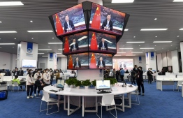 Screens show Chinese President Xi Jinping delivering a speech via video for the opening ceremony of the 3rd China International Import Expo (CIIE) at a media centre in Shanghai on November 4, 2020. PHOTO: STR / AFP
