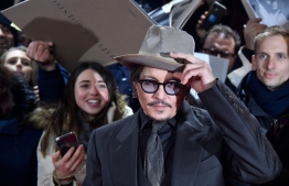 (FILES) In this file photo taken on February 21, 2020 US actor Johnny Depp arrives on the red carpet for the premiere of the film "Minamata" screened in the Berlinale Special Gala at the 70th Berlinale film festival in Berlin. - Hollywood star Johnny Depp on Friday, November 6, confirmed he will appeal against a UK court ruling that upheld claims he was violent towards his ex-wife Amber Heard. (Photo by John MACDOUGALL / AFP)