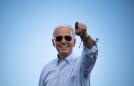 (FILES) In this file photo taken on October 29, 2020 Democratic Presidential candidate and former US Vice President Joe Biden gestures prior to delivering remarks at a Drive-in event in Coconut Creek, Florida. - Joe Biden has won the US presidency over Donald Trump, TV networks projected on November 7, 2020, a victory sealed after the Democrat claimed several key battleground states won by the Republican incumbent in 2016. CNN, NBC News and CBS News called the race in his favor, after projecting he had won the decisive state of Pennsylvania. His running mate, US Senator Kamala Harris, has become the first woman US Vice President elected to the office. PHOTO: JIM WATSON / AFP