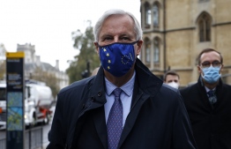EU chief negotiator Michel Barnier wearing a mask because of the novel coronavirus pandemic walks to a conference centre to continue negotiations on a trade deal between the EU and the UK in London on November 9, 2020. (Photo by Tolga Akmen / AFP)