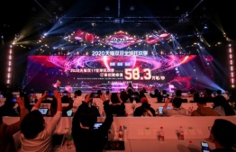 A screen shows sales information during the 2020 Tmall Global Shopping Festival on Singles' Day, also known as the Double 11 shopping festival, at a media centre in Hangzhou, in eastern China's Zhejiang province on November 11, 2020. (Photo by STR / AFP) / 