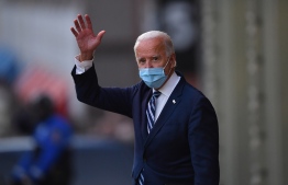 US President-elect Joe Biden waves as he leaves The Queen in Wilmington, Delaware, on November 10, 2020. - President-elect Joe Biden said November 10, 2020 he had told several world leaders that "America is back" after his defeat of Donald Trump in last week's bitterly contested US election. (Photo by Angela Weiss / AFP)