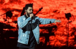 (FILES) In this file photo taken on October 19, 2017, singer The Weeknd performs on his Starboy: Legend of the Fall 2017 World Tour at the AT&T Center in San Antonio, Texas. - Canadian R&B singer The Weeknd will perform at this NFL season's Super Bowl halftime show, the league announced on November 11, 2020, a coveted slot likely to face restrictions due to the ongoing pandemic. (Photo by SUZANNE CORDEIRO / AFP)