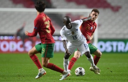France's midfielder N'Golo Kante vies with Portugal's forward Diogo Jota (R) during the UEFA Nations League A group 3 football match between Portugal and France at the Luz stadium in Lisbon on November 14, 2020. (Photo by PATRICIA DE MELO MOREIRA / AFP)