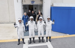 This NASA photo shows NASA astronauts Shannon Walker(L), Victor Glover(2ndL),Mike Hopkins(2ndR) and Japan Aerospace Exploration Agency (JAXA) astronaut Soichi Noguchi(R), wearing SpaceX spacesuits, as they walk out of the Neil A. Armstrong Operations and Checkout Building to depart for Launch Complex 39A during a dress rehearsal prior to the Crew-1 mission launch, on November 12, 2020, at NASA’s Kennedy Space Center in Florida. NASA’s SpaceX Crew-1 mission is the first operational mission of the SpaceX Crew Dragon spacecraft and Falcon 9 rocket travel to the International Space Station as part of the agency’s Commercial Crew Program. NASA astronauts Mike Hopkins, Victor Glover, and Shannon Walker, and astronaut Soichi Noguchi of the Japan Aerospace Exploration Agency (JAXA) are scheduled to launch at 7:49 p.m. EST on November 14,2020 from Launch Complex 39A at the Kennedy Space Center.
Joel KOWSKY / NASA / AFP