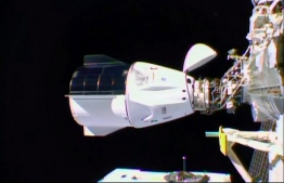 This NASA TV video grab shows Nasa's SpaceX Crew-1 mission aboard the SpaceX Crew Dragon (L) docked to the International Space Station (R) on November 16, 2020. - Four astronauts were successfully launched on the SpaceX Crew Dragon "Resilience" to the International Space Station on November 15, the first of what the US hopes will be many routine missions following a successful test flight in late spring. (Photo by - / NASA TV / AFP) / 