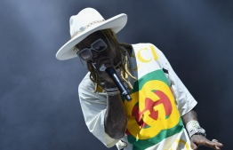 (FILES) In this file photo taken on May 31, 2019 Lil Wayne performs onstage at the 2019 Governors Ball Music Festival on Randall's Islandin New York City. - US rapper Lil Wayne was charged November 17, 2020 in Florida with possession of a firearm by a convicted felon over an incident dating back to last year -- a federal offense that could see him sentenced to up to 10 years in prison. (Photo by Angela Weiss / AFP)