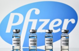 (FILES) This file photo illustration picture shows vials with Covid-19 Vaccine stickers attached, with the logo of US pharmaceutical company Pfizer, on November 17, 2020. (Photo by JUSTIN TALLIS / AFP)