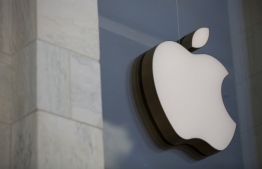 (FILES) In this file photo the Apple logo is seen outside the Apple Store in Washington, DC, on July 9, 2019. - Apple is to slash the commission it takes from small businesses selling programs on its App Store, the company said on November 18, 2020, but the tech giant will still take a 30 percent cut from major developers.The iPhone manufacturer said that from the new year, developers who make less than $1 million from selling apps on its store will see Apple's revenue bite cut to 15 percent. (Photo by Alastair Pike / AFP)