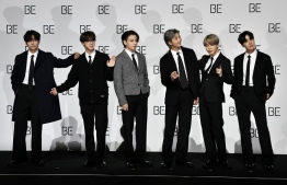 South Korean K-pop boy band BTS members (L to R) V, Jin, Jung Kook, RM, Jimin and J-Hope pose for a photo session during a press conference on BTS new album 'BE (Deluxe Edition)' in Seoul on November 20, 2020. (Photo by Jung Yeon-je / AFP)