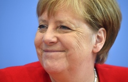(FILES) In this file photo taken on July 19, 2019 German Chancellor Angela Merkel smiles as she speaks during her summer press conference in Berlin. - In power so long she has been dubbed Germany's "eternal chancellor", Angela Merkel's marks 15 years at the helm of Europe's top economic power Sunday, November 22, 2020 with her popularity and public trust scaling new heights as her remaining time in office ticks down. (Photo by John MACDOUGALL / AFP)