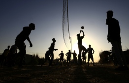 Ethiopian refugees who fled fighting in Tigray province play volleyball at the Um Raquba camp in Sudan's eastern Gedaref province, on November 21, 2020. - Ethiopia's northern Tigray region has been rocked by bloody fighting since November 4, when Ethiopian Prime Minister Abiy Ahmed announced the launch of military operations there. Neighbouring Sudan, itself suffering from a severe economic crisis, was caught off-guard when the conflict broke out earlier this month. It now hosts some 36,000 Ethiopians, with many in transit camps near the border, according to Sudan's refugee commission. (Photo by ASHRAF SHAZLY / AFP)