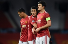 Manchester United's English striker Mason Greenwood (L), Manchester United's Uruguayan striker Edinson Cavani (C) and Manchester United's English defender Harry Maguire prepare a defensive wall during the UEFA Champions league group H football match between Manchester United and Istanbul Basaksehir at Old Trafford stadium in Manchester, north west England, on November 24, 2020. (Photo by Oli SCARFF / AFP)