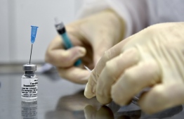(FILES) In this file photo taken on September 10, 2020 a nurse prepares to inoculate volunteer Ilya Dubrovin, 36, with Russia's new coronavirus vaccine in a post-registration trials at a clinic in Moscow. Russia's Sputnik V coronavirus vaccine is 95 percent effective according to a second interim analysis of clinical trial data, its developers said on November 24, 2020. - The vaccine was developed by the Gamaleya research institute in Moscow in coordination with the Russian defence ministry. (Photo by Natalia KOLESNIKOVA / AFP)