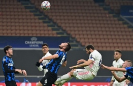 Real Madrid's Spanish defender Nacho Fernandez (3rdR) and Inter Milan's Dutch defender Stefan de Vrij (3rdL) go for a header during the UEFA Champions League Group B football match Inter Milan vs Real Madrid on November 25, 2020 at the Giuseppe-Meazza (San Siro) stadium in Milan. (Photo by MIGUEL MEDINA / AFP)