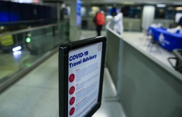 A man waits in line for a coronavirus test at a free walk-up Covid-19 testing site inside Penn Station on December 05, 2020 in New York City. - Many holiday events have been canceled or adjusted with additional safety measures due to the ongoing coronavirus (COVID-19) pandemic. (Photo by Kena Betancur / AFP)