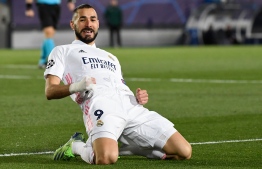 Real Madrid's French forward Karim Benzema celebrates after scoring during the UEFA Champions League group B football match between Real Madrid and Borussia Moenchengladbach at the Alfredo Di Stefano stadium in Valdebebas, northeast of Madrid, on December 9, 2020. (Photo by PIERRE-PHILIPPE MARCOU / AFP)