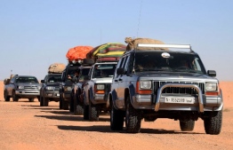 Libyans take part in a 4x4 tourism trip in a desert area near al-Shuwayrif town, some 400 Km southwest of the capital, on December 3, 2020. - In 2010, 110,000 foreign tourists visited Libya, generating $ 40 million, a figure that has dropped to zero since 2011 due to the political chaos and insecurity following the fall of the Moamer Kadhafi regime in 2011. (Photo by Mahmud TURKIA / AFP)