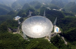 This handout photograph taken on August 24, 2016 and released on December 13, 2020 by the National Astronomical Observatories of the Chinese Academy of Sciences (NAOC) shows the five-hundred-meter Aperture Spherical radio Telescope (FAST) in Pingtang county, in southwestern China's Guizhou province. (Photo by Handout / National Astronomical Observatories of the Chinese Academy of Sciences (NAOC) / AFP) / -----EDITORS NOTE --- RESTRICTED TO EDITORIAL USE - MANDATORY CREDIT "AFP PHOTO / National Astronomical Observatories of the Chinese Academy of Sciences (NAOC) " - NO MARKETING - NO ADVERTISING CAMPAIGNS - DISTRIBUTED AS A SERVICE TO CLIENTS / ìThe erroneous mention[s] appearing in the metadata of this photo by Handout has been modified in AFP systems in the following manner: [This handout photograph taken on August 24, 2016 and released on December 13, 2020] instead of [This handout photograph taken on December 13, 2020]. Please immediately remove the erroneous mention[s] from all your online services and delete it (them) from your servers. If you have been authorized by AFP to distribute it (them) to third parties, please ensure that the same actions are carried out by them. Failure to promptly comply with these instructions will entail liability on your part for any continued or post notification usage. Therefore we thank you very much for all your attention and prompt action. We are sorry for the inconvenience this notification may cause and remain at your disposal for any further information you may require.î