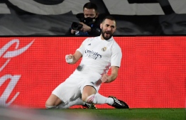 Real Madrid's French forward Karim Benzema celebrates after scoring during the Spanish league football match between Real Madrid CF and Athletic Club Bilbao at the Alfredo di Stefano stadium in Madrid on December 15, 2020. (Photo by OSCAR DEL POZO / AFP)