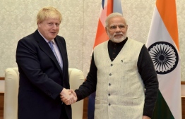 (FILES) In this photograph released by the Press Information Bureau (PIB) on January 18, 2017, British Foreign Secretary Boris Johnson (L) shakes hands with Indian Prime Minister Narendra Modiv (R) in New Delhi. - British Prime Minister Boris Johnson will travel to India in January 2021 in his first major bilateral visit to another country since taking power last year, his office said Tuesday. (Photo by - / PIB / AFP)