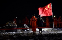 The return module of China's Chang'e-5 lunar probe lands in Siziwang Banner, in northern China's Inner Mongolia Autonomous Region on December 17, 2020. (Photo by STR / AFP) / 