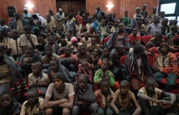 Released students gather at the Government House with other students from the Government Science Secondary school, in Kankara, in northwestern Katsina State, Nigeria upon their release on December 18, 2020. - More than 300 Nigerian schoolboys were released on Thursday after being abducted in an attack claimed by Boko Haram, officials said, although it was unclear if any more remained with their captors (Photo by Kola SULAIMON / AFP)