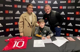 Manchester United's former record goalscorer Wayne Rooney posted a picture of son Kai Rooney - signing a contract with the same club. Though Kai is only 11 and has a long ways ahead, fans remember his father's starry debut at 16 and eagerly anticipate a continued legacy. PHOTO: TWITTER / WAYNE ROONEY