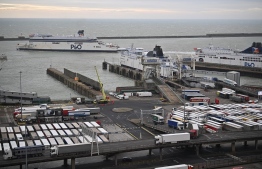 Lorries disembark while others wait to board as a P&O ferry arrives at the port of Dover on the south coast of England on December 18, 2020. - Questions were asked in the House of Lords on December 17 on the government's state of preparedness for Brexit. UK importers are suffering from delays at Felixstowe and Southampton and there are fears of major delays at Dover from the new year. (Photo by Ben STANSALL / AFP)
