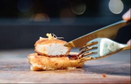 This undated handout from Eat Just released on December 19, 2020 shows a nugget made from lab-grown chicken meat at a restaurant in Singapore, which became the first country to allow meat created without slaughtering any animals to be sold. (Photo by Handout / Eat Just / AFP) /