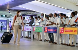 (FILE) Tourist searching for their pick up among airport representatives with placards, in photo taken on December 21, 2020: over 923,000 tourists have arrived this year so far -- Photo: Nishan Ali/ Mihaaru