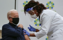US President-elect Joe Biden receives a Covid-19 vaccination from Tabe Mase, Nurse Practitioner and Head of Employee Health Services, at the Christiana Care campus in Newark, Delaware on December 21, 2020.