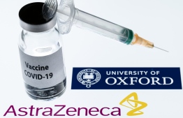 (FILES) In this file photo taken on November 23, 2020 This illustration picture taken in Paris shows a syringe and a bottle reading "Covid-19 Vaccine" next to AstraZeneca company and University of Oxford logos. (Photo by JOEL SAGET / AFP)